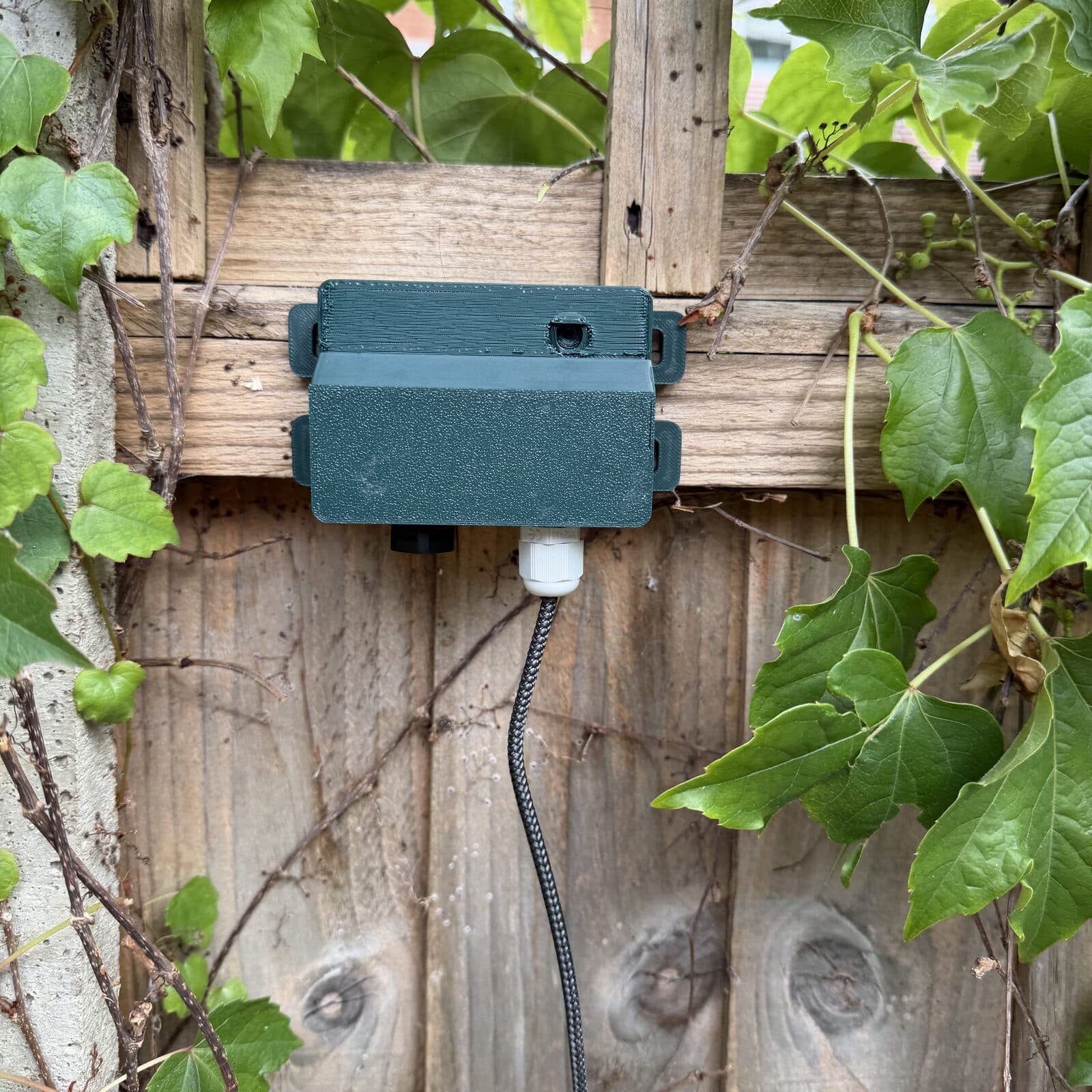 The listening post seen head-on where it is mounted, showing the sealed cable gland on its underside.